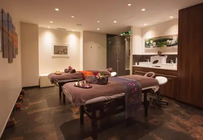 a therapy room with three beds and a kitchen at Westminster Hotel & Spa Nice in Nice