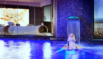 a woman in a swimming pool at a hotel at Westminster Hotel & Spa Nice in Nice
