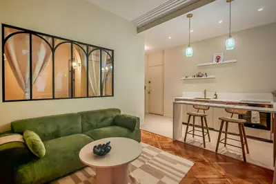 a kitchen with a counter and chairs in a room at T2 refait à neuf - Mer & Promenade des Anglais - Negresco in Nice