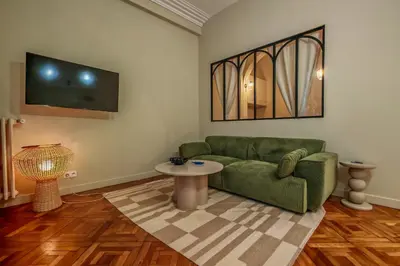 a living room with a couch and a tv at T2 refait à neuf - Mer & Promenade des Anglais - Negresco in Nice