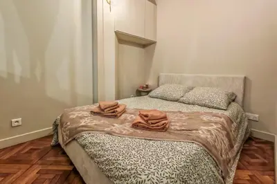 a bedroom with a bed and a mirror and lights at T2 refait à neuf - Mer & Promenade des Anglais - Negresco in Nice