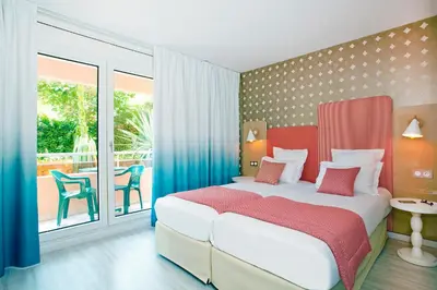 a bedroom with a large bed and a balcony at Residhome Nice Promenade in Nice