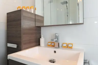 a bathroom with a white sink and a mirror at Nice Étoile Grand Suite Five stars Holiday House in Nice