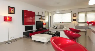 a living room with red furniture and red chairs at Nice Étoile Grand Suite Five stars Holiday House in Nice