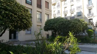 a large building with trees in front of it at Palais Rialto in Nice