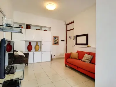 a living room with a red couch and a tv at Nestor&Jeeves - PALAIS NICOLE - Central - Very close sea in Nice