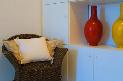 a chair with a pillow and a vase on a shelf at Nestor&Jeeves - PALAIS NICOLE - Central - Very close sea in Nice