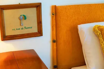 a picture of a key on a wall next to a bed at Nestor&Jeeves - PALAIS NICOLE - Central - Very close sea in Nice