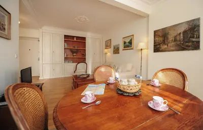 a room with a wooden table and chairs at Appartement Clemenceau Centre Nice Five stars Holiday House in Nice