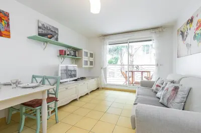 a living room with a table and a couch at Nice 1 Bedroom downtown Carré d'Or with garage in Nice
