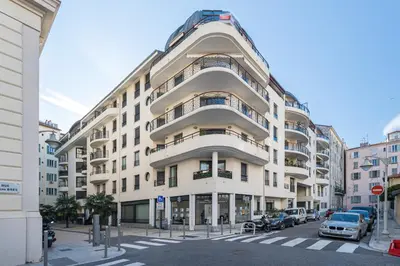 a large white building with cars parked in front of it at Nice 1 Bedroom downtown Carré d'Or with garage in Nice