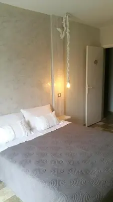 a bedroom with a large bed in a room at La maison de lulu in Nice