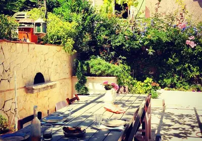 a long table with plates and wine bottles on it at La maison de lulu in Nice