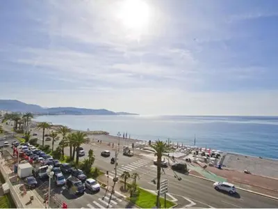 a parking lot with cars parked next to the ocean at LE MIRAGE, SEA FRONT view, 3 bedrooms, 100m in Nice