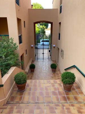 an entrance to a building with a gate and potted plants at Saint Jean Cap Ferrat in Saint-Jean-Cap-Ferrat