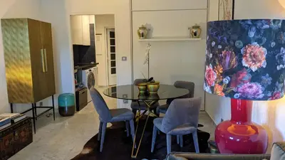 a living room with a glass table and chairs at Saint Jean Cap Ferrat in Saint-Jean-Cap-Ferrat