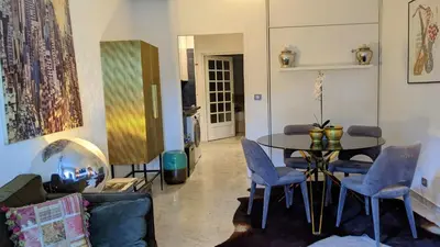 a living room with a table and chairs at Saint Jean Cap Ferrat in Saint-Jean-Cap-Ferrat