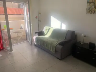 a couch sitting in a living room next to a table at Appartement Fodéré 2 in Nice