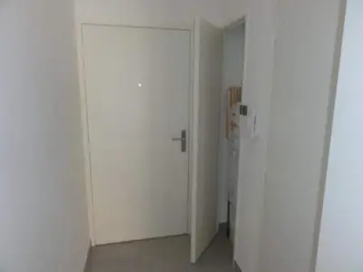 a white door in a room with a refrigerator at Appartement Fodéré 2 in Nice
