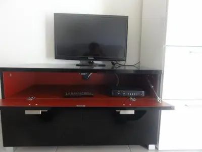 a tv on top of a wooden entertainment center at Appartement Fodéré 2 in Nice