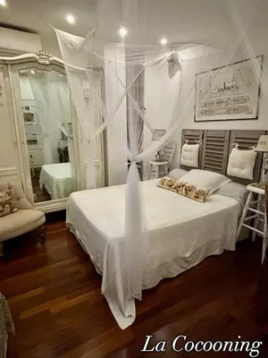 a bedroom with a white bed and a mirror at Chambre calme centre Nice labellisée in Nice