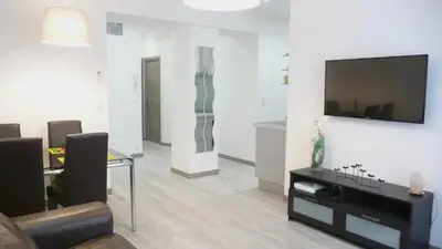 a living room with a flat screen tv on a wall at Carré d'or Very nice appart Near the beach in Nice