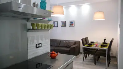 a kitchen and living room with a couch and a table at Carré d'or Very nice appart Near the beach in Nice
