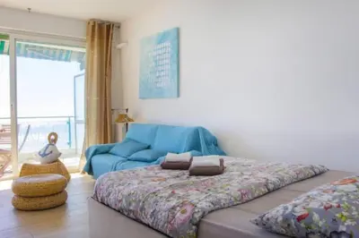 a bedroom with a bed and a blue couch at MY CASA - PROM 13 - Sea View - Promenade des Anglais - Terrace in Nice