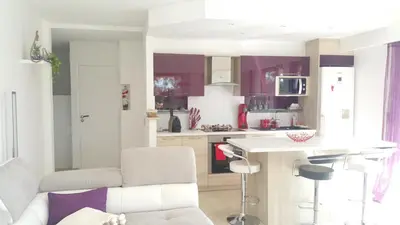 a kitchen with purple cabinets and a white counter top at Roc et Galets in Saint-Laurent-du-Var