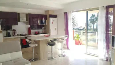 a kitchen with a counter and a view of a balcony at Roc et Galets in Saint-Laurent-du-Var