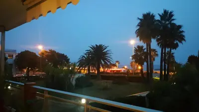 a view of a park with palm trees at night at Roc et Galets in Saint-Laurent-du-Var