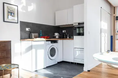 a white kitchen with a washing machine and a sink at 1 Bdr Downtown near Place Massena in Nice