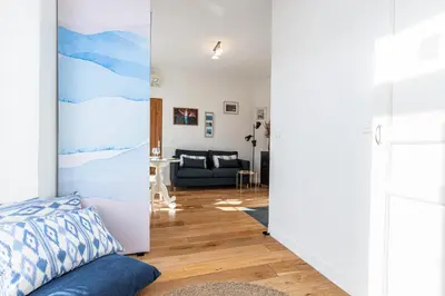 a living room with a sliding door leading into a bedroom at 1 Bdr Downtown near Place Massena in Nice