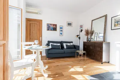 a living room with a blue couch and a table at 1 Bdr Downtown near Place Massena in Nice