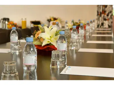 a row of bottles of water sitting on a table at Hôtel Du Baou in La Gaude