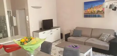 a living room with a couch and a table at Au Coeur du vieux Nice in Nice
