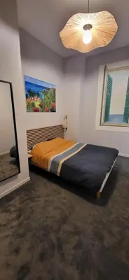 a bedroom with a bed and a ceiling fan at Au Coeur du vieux Nice in Nice