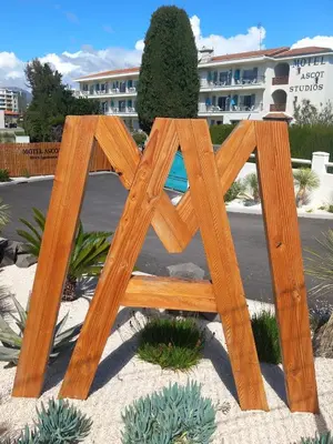 a bedroom with a bed and a door with a dancer on it at MOTEL ASCOT - Hotel & Appartements in Cagnes-sur-Mer