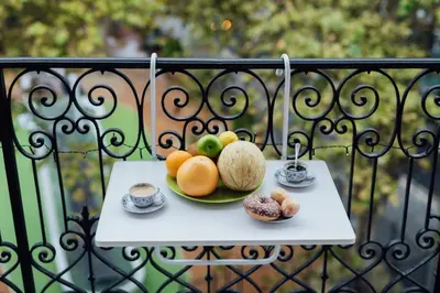 a plate of fruit on a table on a balcony at Nice Appartement Rue D'Italie in Nice