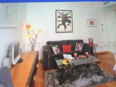 a living room with a couch and a coffee table at Carre d or in Nice
