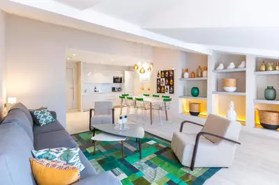 a living room with a couch and a table at Palais Saleya Boutique Hôtel in Nice