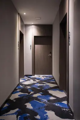 a hallway with a blue and white floor in a building at Palais Saleya Boutique Hôtel in Nice