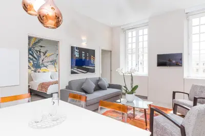 a living room with a couch and a table at Palais Saleya Boutique Hôtel in Nice
