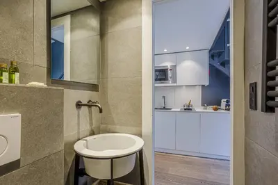 a small bathroom with a sink and a kitchen at MY CASA - 4 PLACE MASSENA - DUPLEX in Nice