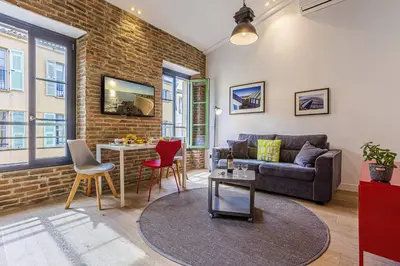 a living room with a couch and a table at MY CASA - 4 PLACE MASSENA - DUPLEX in Nice
