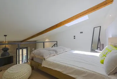 a bedroom with a large bed and a large window at MY CASA - 4 PLACE MASSENA - DUPLEX in Nice