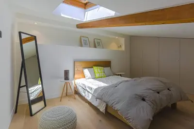 a bedroom with a large bed and a skylight at MY CASA - 4 PLACE MASSENA - DUPLEX in Nice