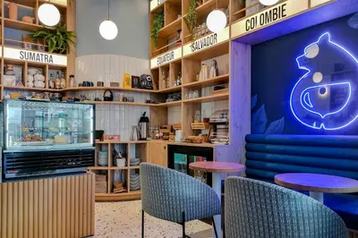 a restaurant with blue chairs and tables in a store at Hôtel Du Centre, un hôtel AMMI in Nice