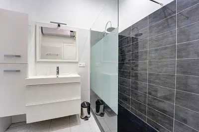 a bathroom with a sink and a shower at L'Écrin Blanc Niçois - Welkeys in Nice