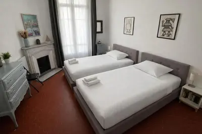 a bedroom with a white bed and a window at L'Écrin Blanc Niçois - Welkeys in Nice